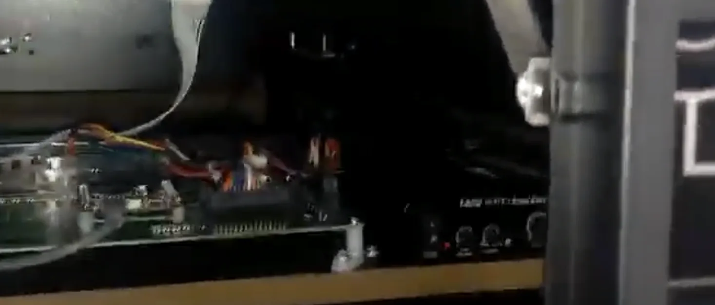 The audio amplifier with volume and bass knobs inside the pinball cabinet.