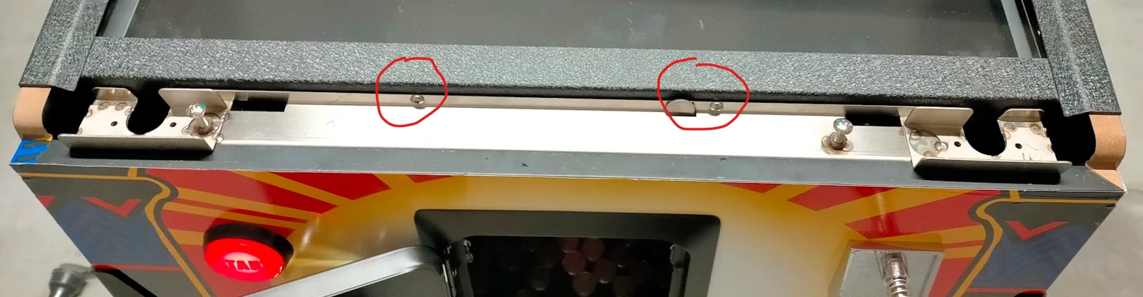 Removing the side metal profiles of the pinball playfield.