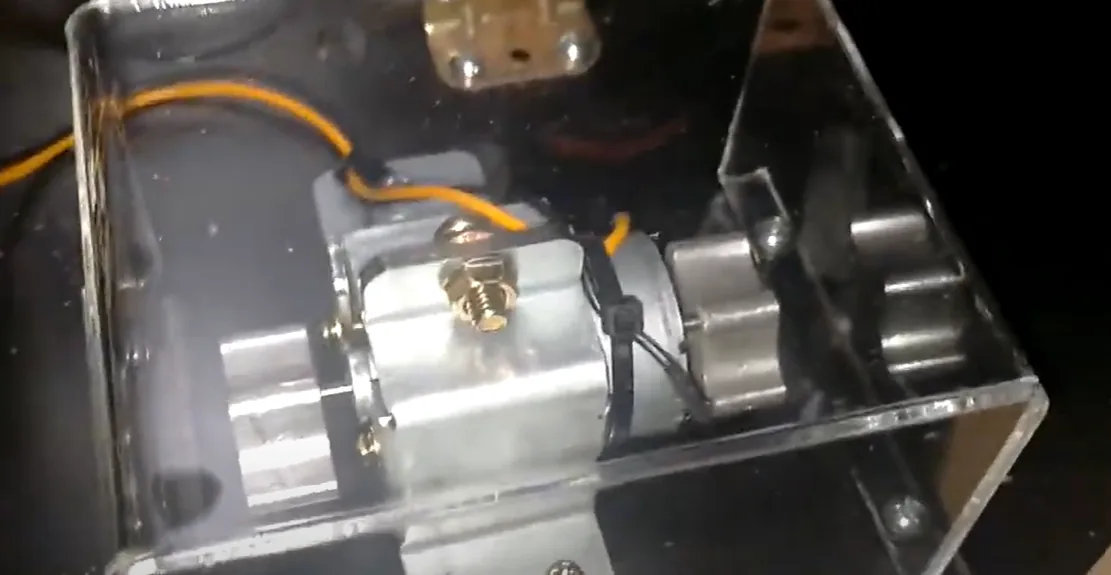 The force-feedback vibration motor assembly inside the pinball cabinet.